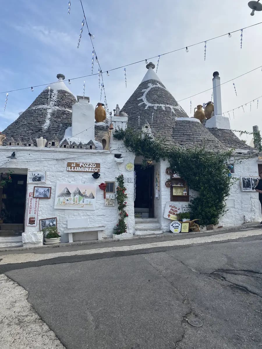 trullis in alberobello with symbols on the roof 