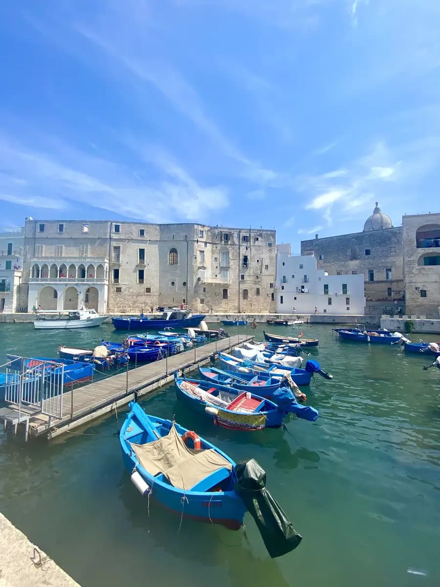 gozzi fisherman boats in the old harbour in monopoli