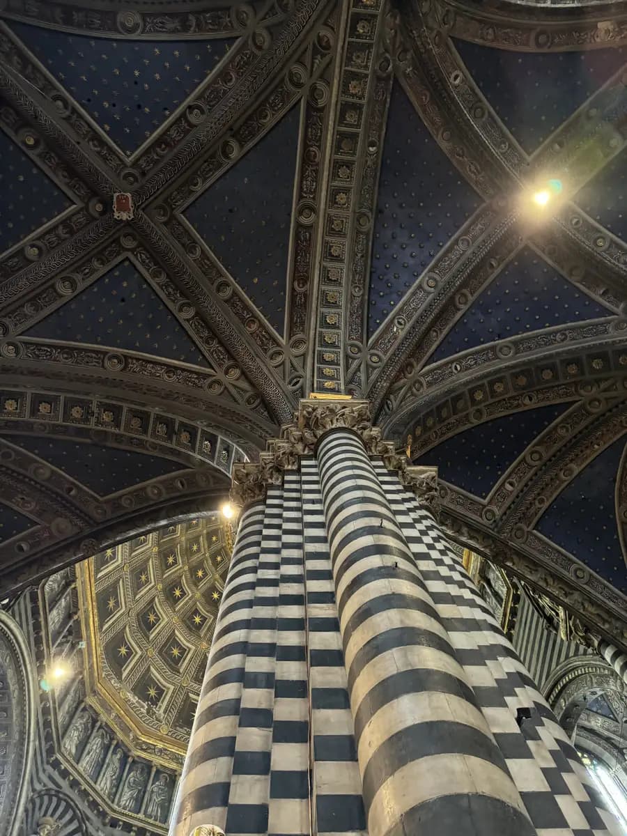 picture of the arches and grand pillars blue and white and gold colour in the siena cathedral