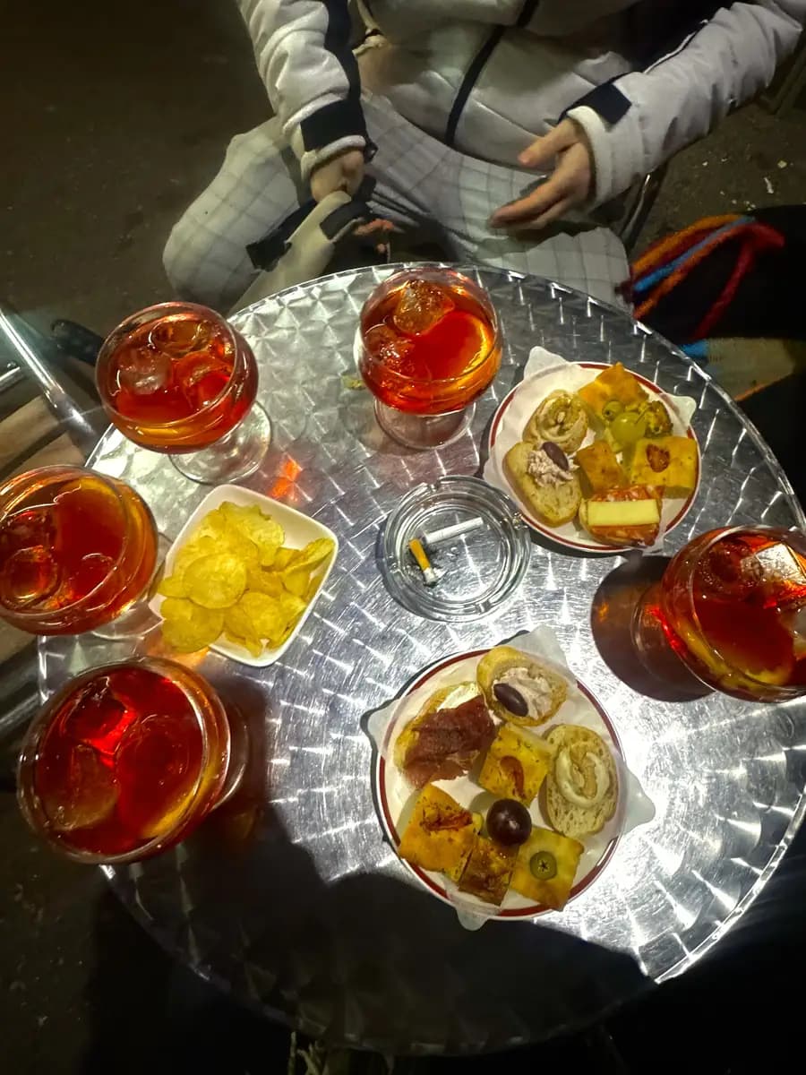 picture of negroni sbagliatos with crisps, olives and bread with meat (aperitivos)
