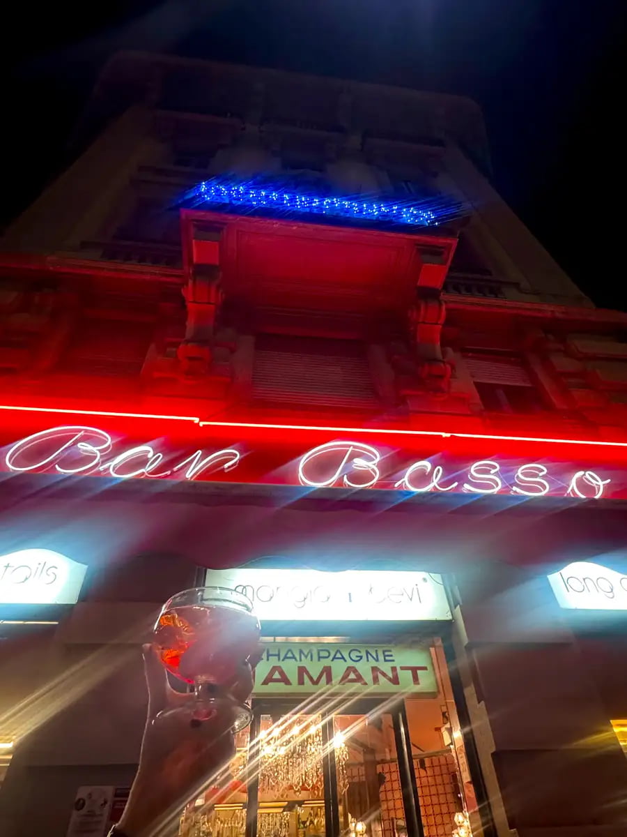outside bar basso milano holding up a negroni sbagliato milan