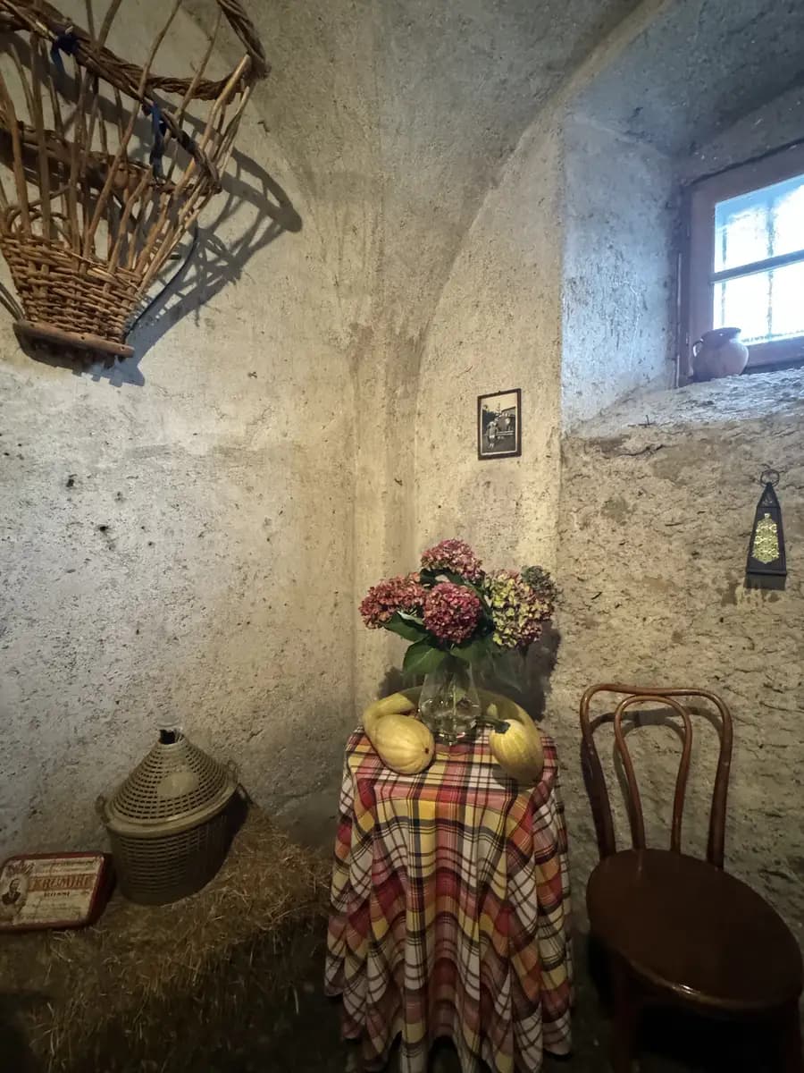 nicely decorated table inside a wine cellar with pumpkins and flowers