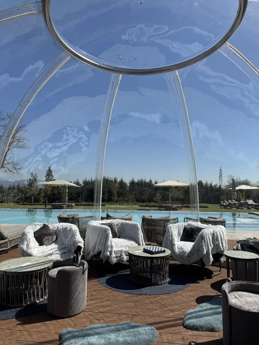 inside the domes in the spa with a game of chess on the table and cosy blankets wrapped on the chairs