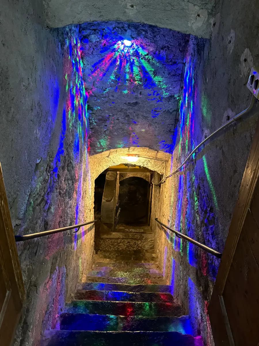 stairs down to wine cellar with colourful strobe lights